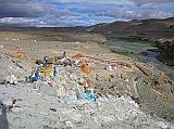 Tibet Kailash 06 Tirthapuri 11 View From Pass On Kora After the hot springs the trail climbs past a cremation area consecrated to Yeshe Tsogyal, and then reaches a miniature version of Kailash's Dlma La, marked with mani stones, prayer flags and a large collection of yak horns and skulls. To the left is the end of a recently constructed over 200m long mani wall, which points to the northeast directly towards Mount Kailas. The wall was the end result of a demon firing an arrow at the guru. He stopped the arrow's flight and transformed it into this wall.